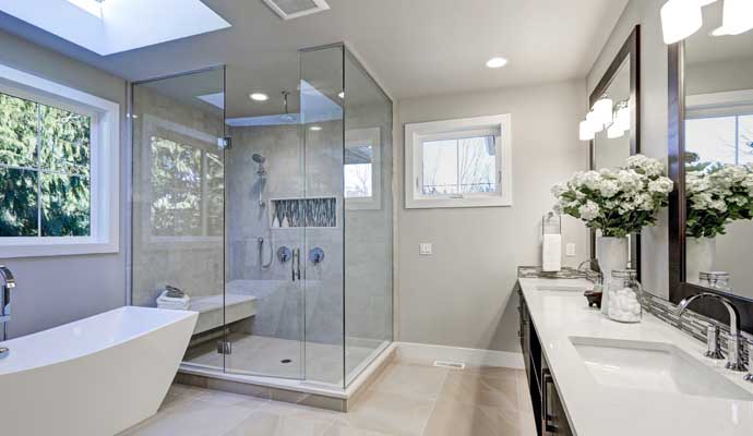 Newly remodeled bathroom with tub and glass-enclosed shower A modern bathroom featuring a bathtub and a dedicated shower area